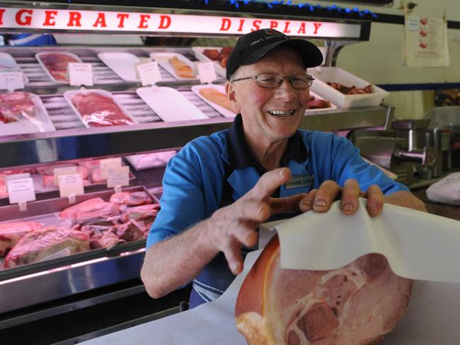 Shortage of fresh Australian-produced ham for Christmas. Graham Linke from Linke's Central Meat Store in Nuriootpa sells customer Reg Wilson his pre-ordered leg of ham.