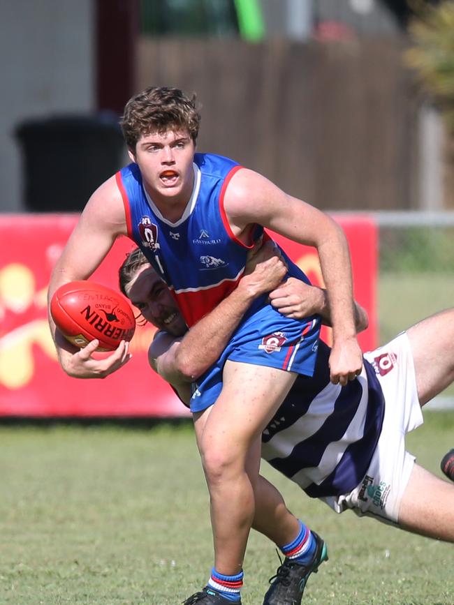 Jaiden Butson is wrapped up by Ethan McCollough in the AFL Cairns seniors match between Centrals Trinity Beach Bulldogs and Port Douglas Crocs, held at Crathern Park, Trinity Beach. Picture: Brendan Radke