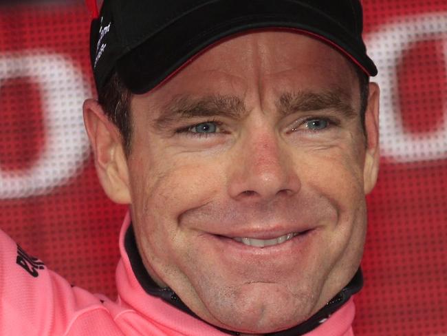 Australian rider Cadel Evans celebrates the pink jersey on the podium of the 8th stage of the 97th Giro d'Italia, Tour of Italy, cycling race from from Foligno to Montecopiolo on May 17, 2014 in Montecopiolo. AFP PHOTO / LUK BENIES