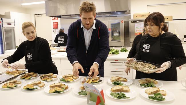 Ambassador Curtis Stone helped launch the Coles SecondBite Winter Appeal by rolling up his sleeves in the kitchen with volunteer cooks preparing breakfast for ADRA clients affected by homelessness and food insecurity. Picture: Alex Coppel