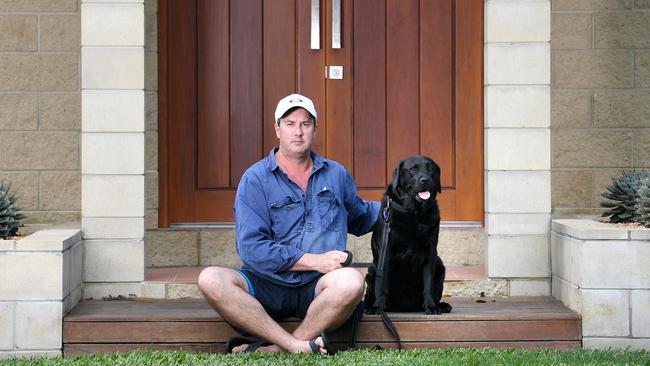 Nome resident Christian Petersen with his 6-year-old Labrador, Maddie, is concerned with the aggressive dogs in his neighbourhood. Picture: Shae Beplate.