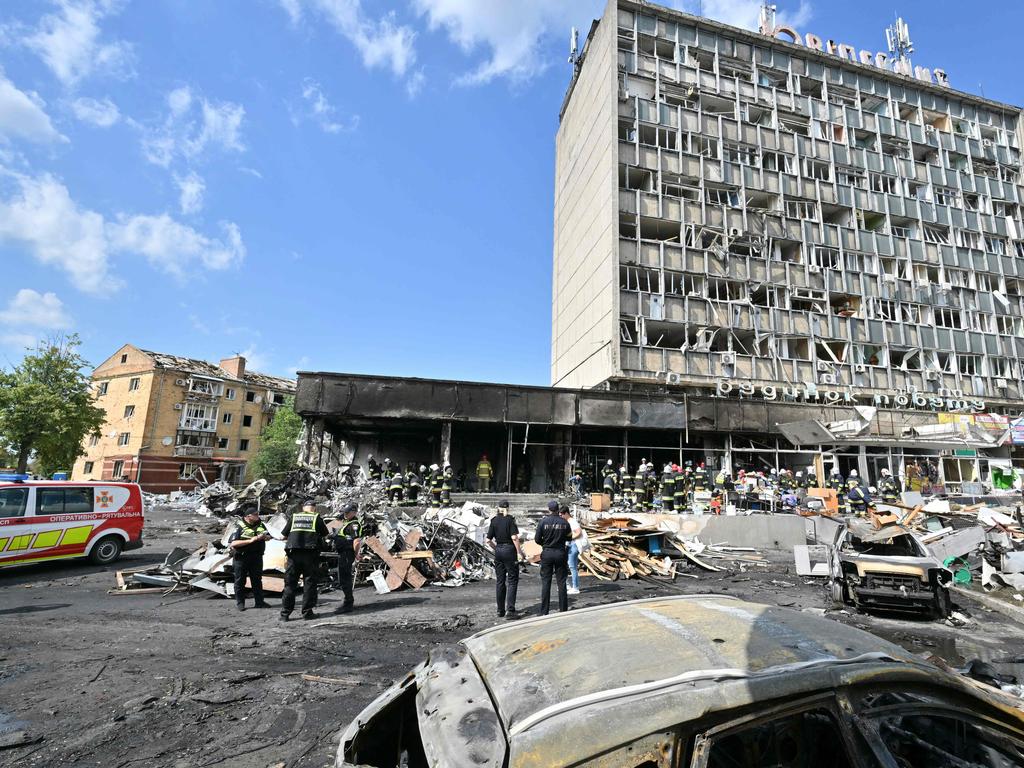 Firefighters inspect a damaged building following a Russian air strike in the city of Vinnytsia, west-central Ukraine on July 14, 2022. Picture: Sergei Supinsky / AFP.