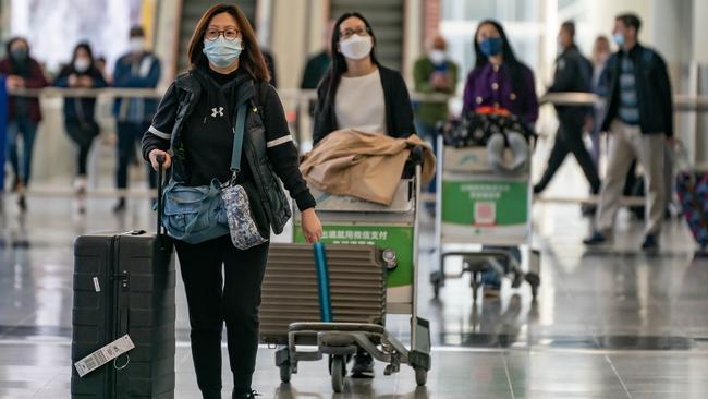 Travellers at Hong Kong International Airport as authorities around the world impose or consider curbig travellers from China. Picture: Getty Images