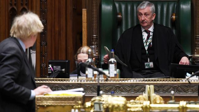 Speaker of the House of Commons Lindsay Hoyle listens to Boris Johnson as he reveals the road map out of the third coronavirus lockdown. Picture: AFP.