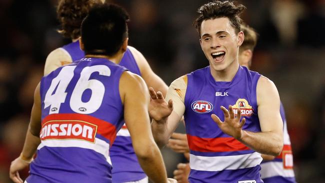 Toby McLean celebrates a goal with Lin Jong.