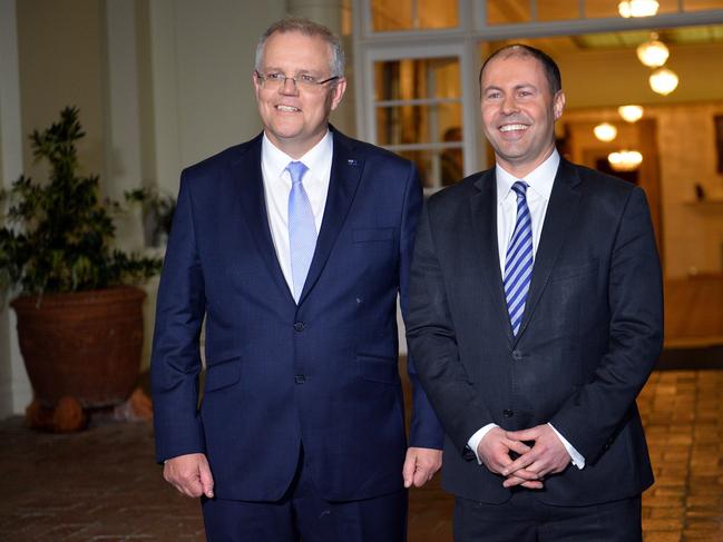 New Australian Prime Minister Scott Morrison (L) and deputy Liberal party leader Josh Frydenberg (R) pose for photos following the oath-taking ceremony of the prime minister's office in Canberra on August 24, 2018. - Scott Morrison was sworn in as Australia's seventh prime minister in 11 years on August 24 after a stunning party revolt against Malcolm Turnbull, which the new leader admitted had left the government "bruised and battered". (Photo by SAEED KHAN / AFP)