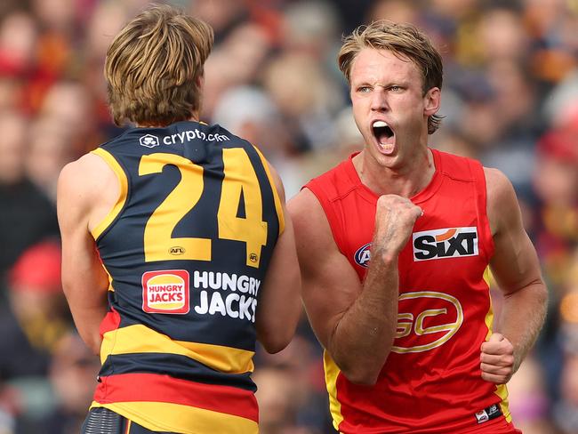 Adelaide, AUSTRALIA - AUGUST 5: Jack Lukosius of the Suns celebrates a goal as he comes towards Josh Worrell of the Crows during the 2023 AFL Round 21 match between the Adelaide Crows and the Gold Coast SUNS at Adelaide Oval on August 5, 2023 in Adelaide, Australia. (Photo by Sarah Reed/AFL Photos via Getty Images)