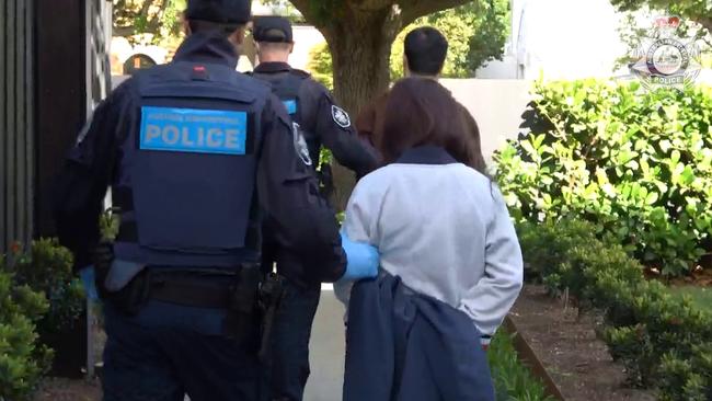 Chen Zhou, 37, and Lu Jie, 28, are led away from a property on Knutsford Street, Balwyn. The pair were arrested as part of Operation Avarus-Nightwolf, conducted by the AFP.,