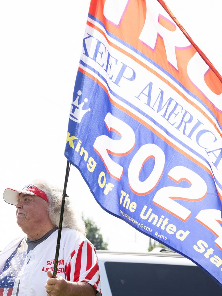 Trump supporter Sharon Anderson waves a flag outside of the Fulton County Jail. (Photo by Jessica McGowan / GETTY IMAGES NORTH AMERICA / Getty Images via AFP)