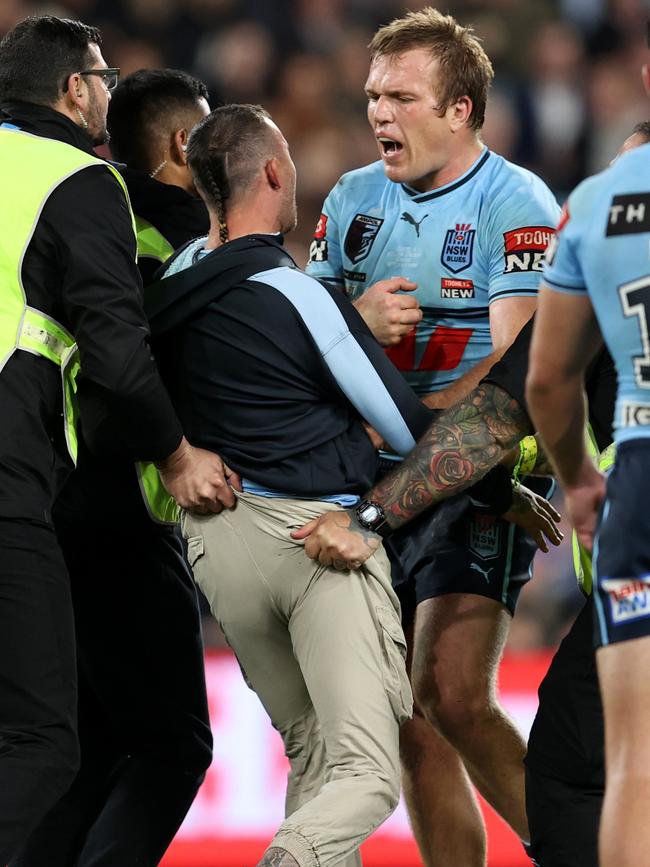 Jake Trbojevic comes face-to-face with a pitch invader. Picture: Brendon Thorne/Getty