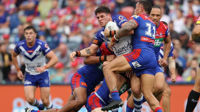 Canterbury’s Adam Elliott of the Bulldogs is swamped by the Newcastle defence led by Tyson Frizell (right) at McDonald Jones Stadium. Picture: Getty Images.