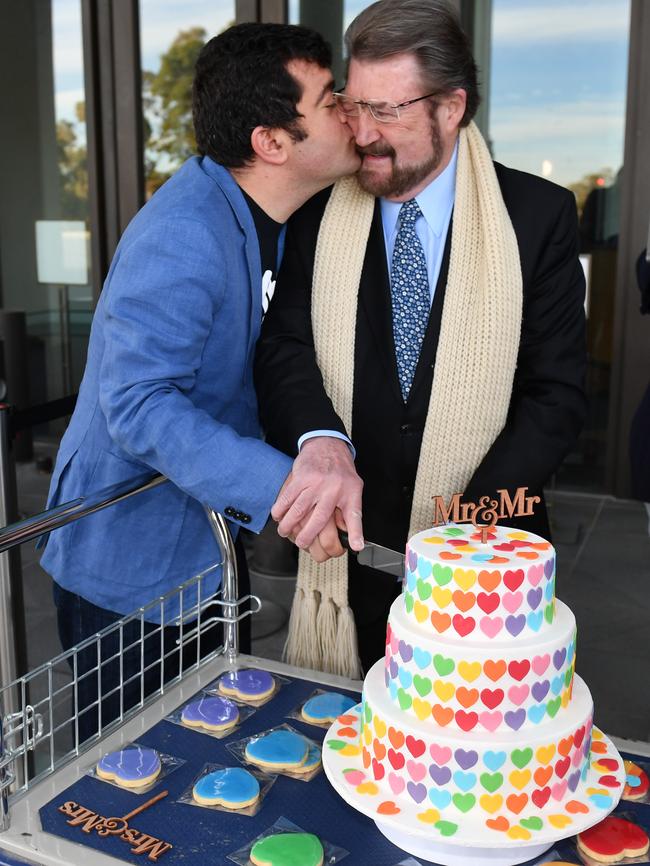 Kissing Justice Party Senator Derryn Hinch while cutting a cake to promote Marriage Equality in August. Picture: Mick Tsikas