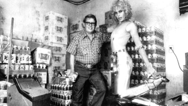 Billy Carter poses with model Marqaux Hemingway in Carter's petrol station in Plains, Georgia, in 1977.
