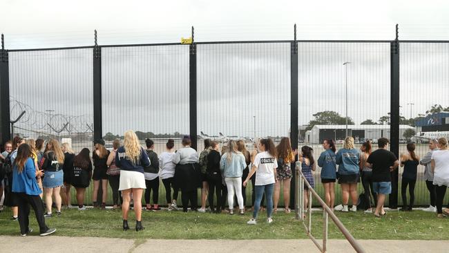 Fans lines up near the tarmac awaiting the pop star’s arrival. Picture: Adam Taylor