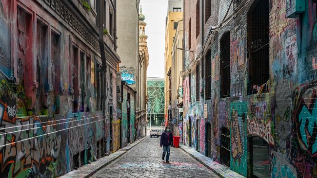 A lone person is seen waling through the usually popular graffiti lined Hosier Lane in July 2020 in Melbourne.