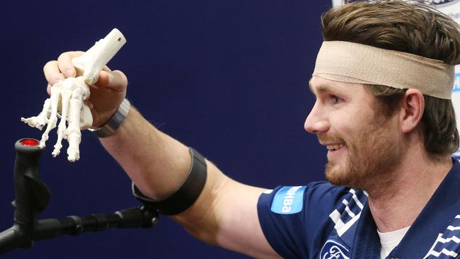 Patrick Dangerfield has a laugh with reporters as he shows his foot problems. Picture: Mark Wilson