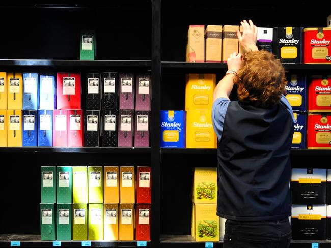 Cask wine is tipped to go up in price - Sales assistant Alister Pike stocking shelves at Booze Brothers bottle shop, Unley Road, Parkside.