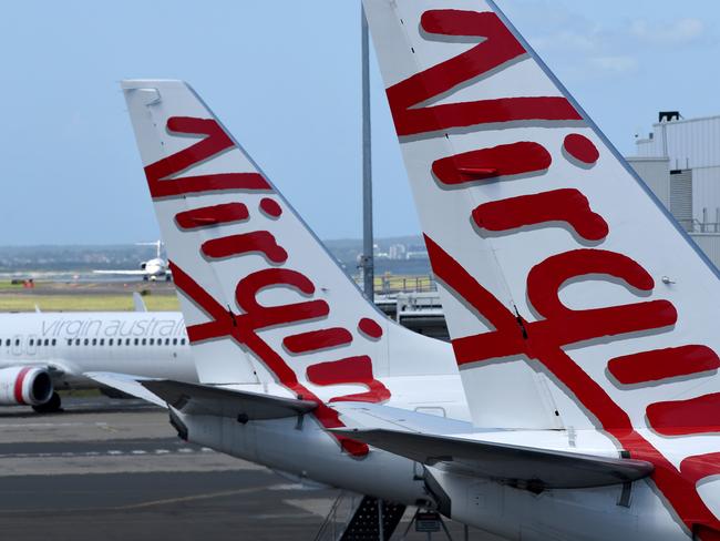 SYDNEY, AUSTRALIA - NCA NewsWire Photos FEBRUARY, 4, 2021: Virgin Australia aircraft are seen on the tarmac at Sydney Domestic Airport, Sydney. Virgin Australia says the end of JobKeeper in March could signal a mass shedding of workers if no further support is provided to the struggling aviation industry which has been out of action for almost one year. Picture: NCA NewsWire/Bianca De Marchi