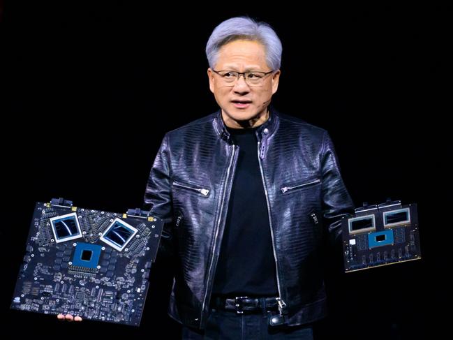 (FILES) NVIDIA's CEO Jensen Huang displays products on-stage during the annual Nvidia GTC Artificial Intelligence Conference at SAP Center in San Jose, California, on March 18, 2024. The torrid rally in Nvidia and other artificial intelligence-linked equities took a pause June 20, 2024, leaving the tech-centered Nasdaq lower following seven straight records. Both the Nasdaq and the S&P 500 retreated from records, while the Dow pushed higher following an up session on European bourses. (Photo by JOSH EDELSON / AFP)