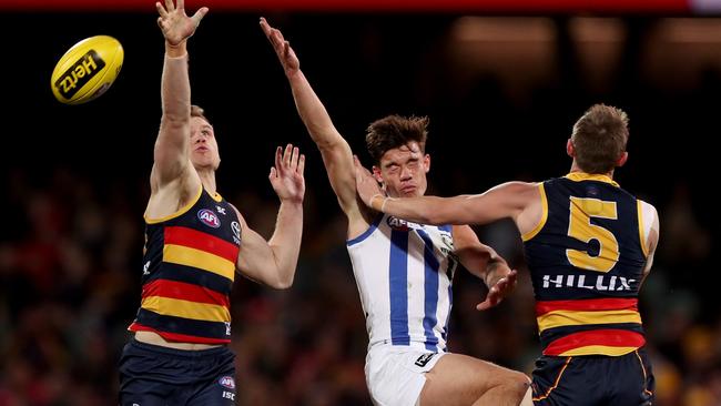 Crows Rory Laird and Matt Crouch, right, clash with Kangaroo Jy Simpkin. Picture: James Elsby/AFL Media/Getty Images