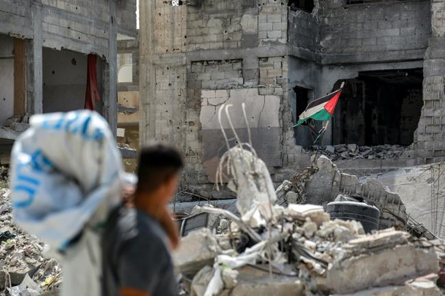 A tattered Palestinian flag flying in a ruined building in southern Gaza's Khan Yunis, nearly a year into the war