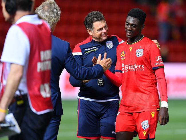 ADELAIDE, AUSTRALIA - FEBRUARY 14: Mohamed Toure of Adelaide United is congratulated by Gertjan Verbeek coach of Adelaide United and Carl Veart assistant coach of Adelaide United  after the round 19 A-League match between Adelaide United and the Central Coast Mariners at Coopers Stadium on February 14, 2020 in Adelaide, Australia. (Photo by Mark Brake/Getty Images)