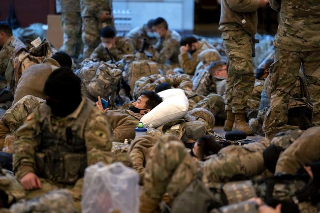 WASHINGTON, DC - JANUARY 13: Members of the National Guard sleep in the Visitor Center of the U.S. Capitol on January 13, 2021 in Washington, DC. Security has been increased throughout Washington following the breach of the U.S. Capitol last Wednesday, and leading up to the Presidential inauguration. Stefani Reynolds/Getty Images/AFP