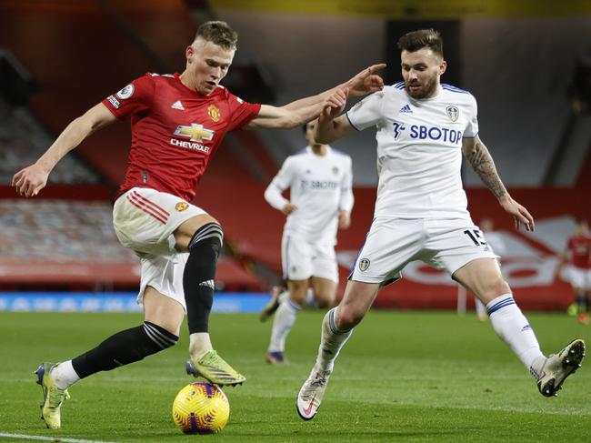 MANCHESTER, ENGLAND - DECEMBER 20: Scott McTominay of Manchester United battles for possession with Stuart Dallas of Leeds United  during the Premier League match between Manchester United and Leeds United at Old Trafford on December 20, 2020 in Manchester, England. The match will be played without fans, behind closed doors as a Covid-19 precaution. (Photo by Clive Brunskill/Getty Images)
