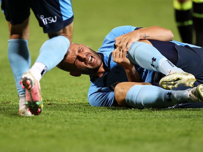 SYDNEY, AUSTRALIA - FEBRUARY 08: Chris Zuvela of Sydney FC holds his knee as he lies injured on the ground during the A-League match between Sydney FC and the Wellington Phoenix at Netstrata Jubilee Stadium, on February 08, 2021, in Sydney, Australia. (Photo by Mark Kolbe/Getty Images)