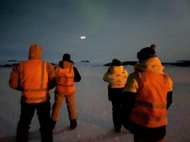 Mawson station expeditioners watch the C-17A military plane approach. Picture: Gemma Woldendorp/AAD