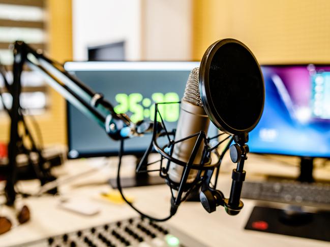 Microphone and mixer at the radio station studio broadcasting news. iStock
