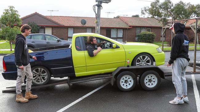 A ute is driven onto a trailer after it was deemed too dangerous to drive home. Picture: Brendan Beckett