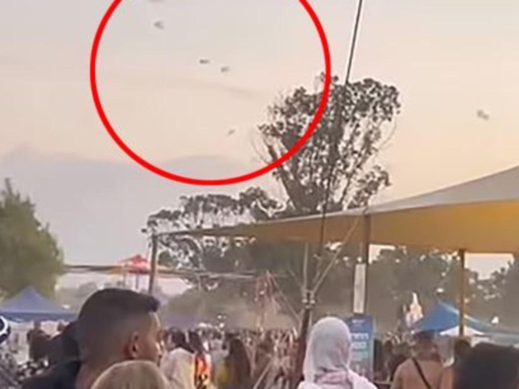 Hamas militants on paragliders are seen over the festival.