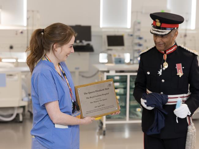 Sir Kenneth Olisa, the Lord-Lieutenant of Greater London, unveils a plaque to formally open the hospital unit last Wednesday, when the Queen made her video call. Picture: Buckingham Palace via Getty Images.