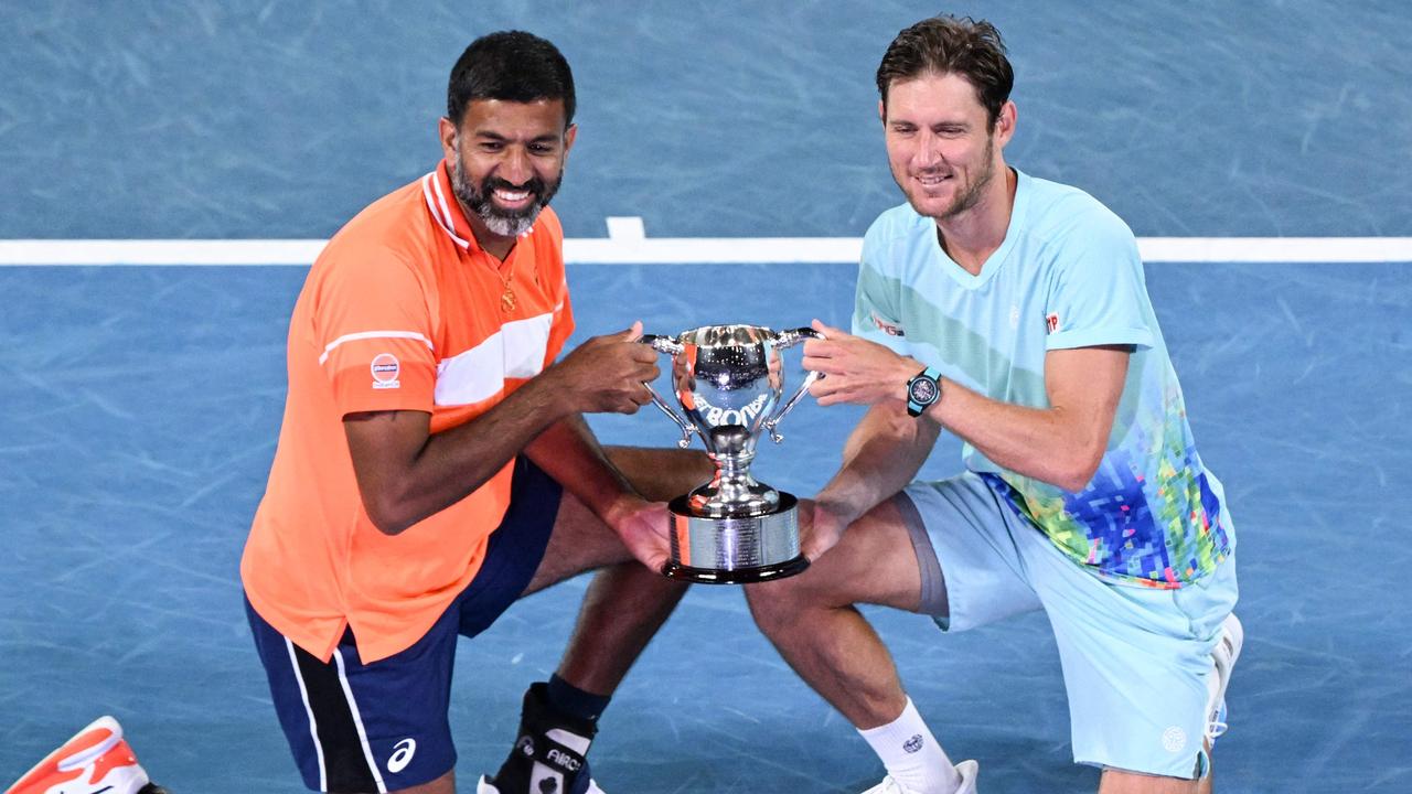 India’s Rohan Bopanna and Australia’s Matthew Ebden celebrate with the Australian Open doubles trophy. Picture: William West / AFP