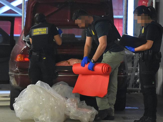 Australian Border Force officers after a dawn raid in Melbourne. Picture: Nicole Garmston