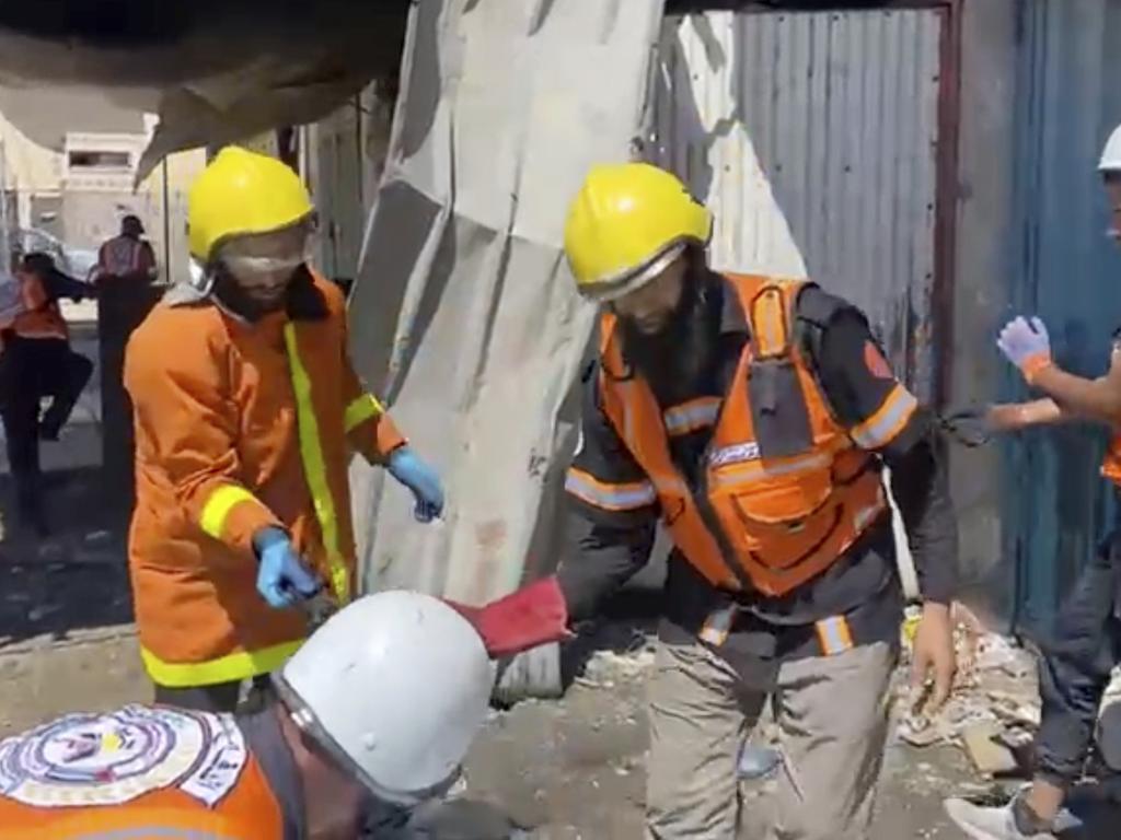 Workers collect human remains after an Israeli strike on a home in Khan Younis killed nine of a doctor’s ten children while she was at work. Picture: Gaza Civil Defense via AP