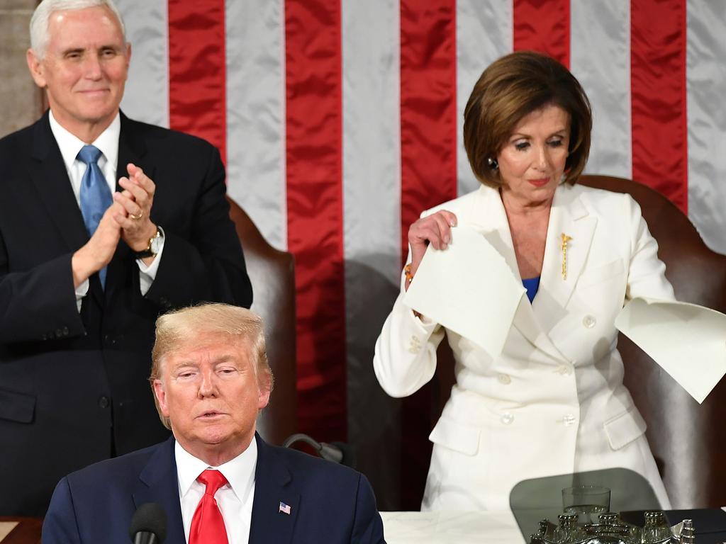 Nancy Pelosi tears up Donald Trump’s State of the Union speech notes as Mike Pence smiles. Picture: AFP