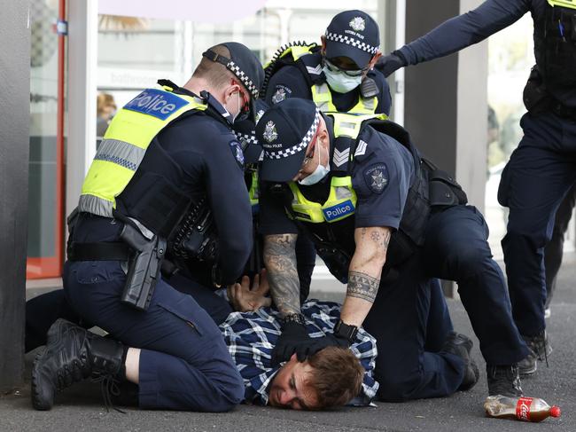 Police tackle an anti-lockdown protester. Picture: Alex Coppel