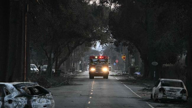 A firetruck drives up a street with charred vehicles left by the Eaton Fire in Altadena, California. Picture: AFP