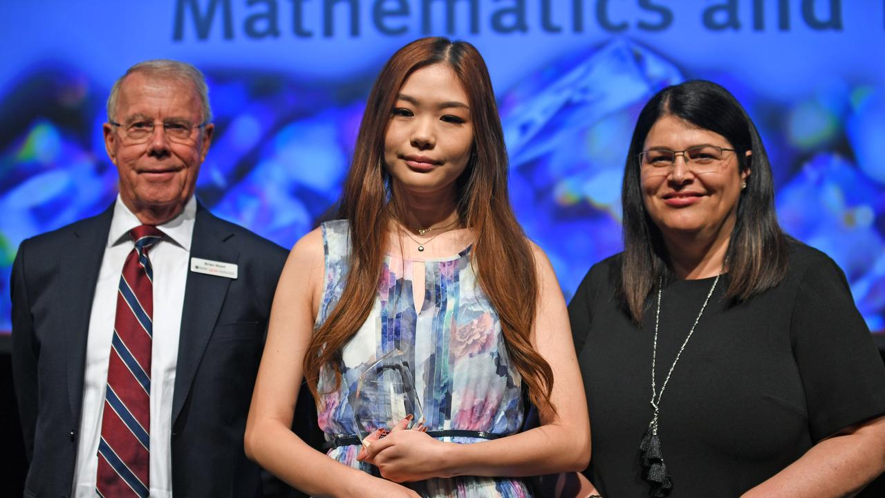 Serena Chen with chairman of QCAA Brian Short and MP Grace Grace. The Queensland Academy for science mathematics and Technology student won the award for the Highest Achievement in the International Baccalaureate. Picture: AAP/John Gass