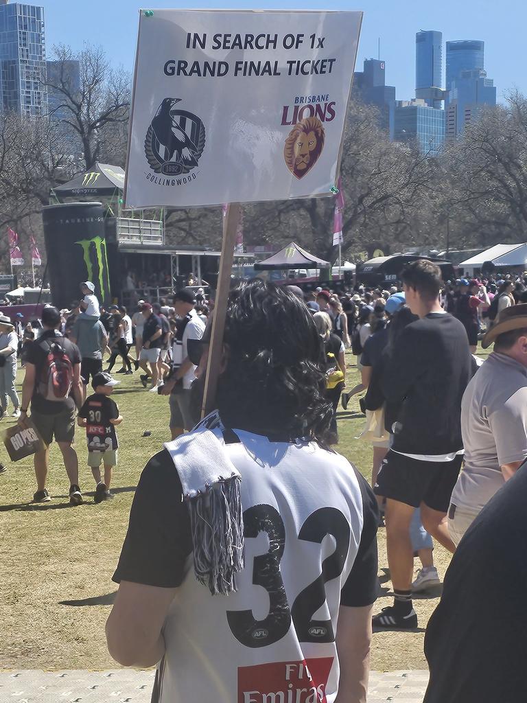 A desperate Collingwood fan tries his luck at the parade. Picture: Supplied