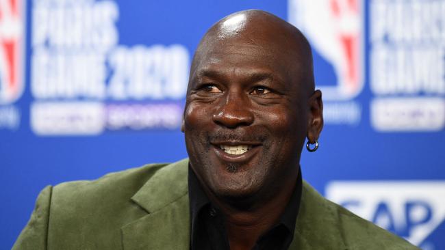 Michael Jordan has reason to smile. Photo by FRANCK FIFE / AFP.