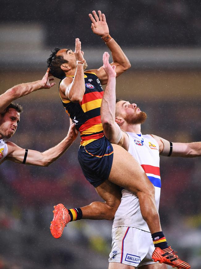 Adelaide’s Eddie Betts flies for a mark over Bulldog Matt Suckling.