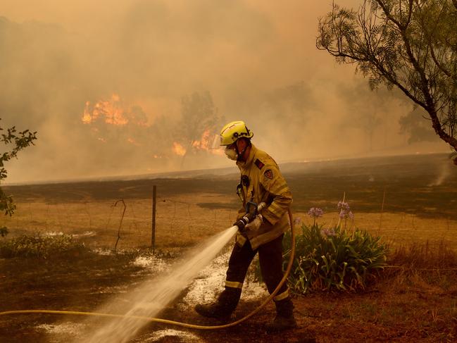 Fire and Rescue NSW fireys put out spot fires in the Bega Valley near Wyndham. Picture: Toby Zerna