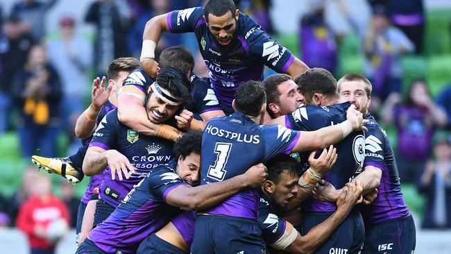 Kenny Bromwich of the Storm is congratulated by teammates after scoring a try against the Eels.