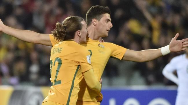 Jackson Irvine and Tomi Juric celebrate after Juric celebrates scoring for the Socceroos against Saudi Arabia.
