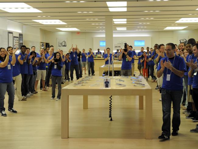 <p>Employees clap as the first customers for the iPad enter the Apple Store at West Farms Mall in Farmington, Connecticut, on April 3, 2010. Picture: AFP / Timothy A. Clary</p>