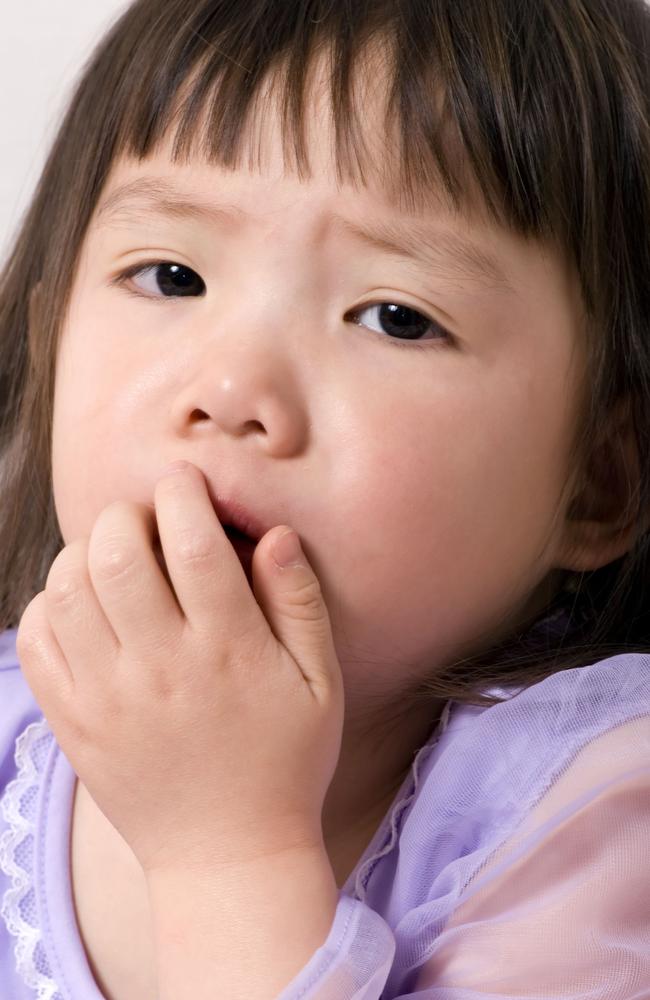 Picture of a child coughing. Stock image.