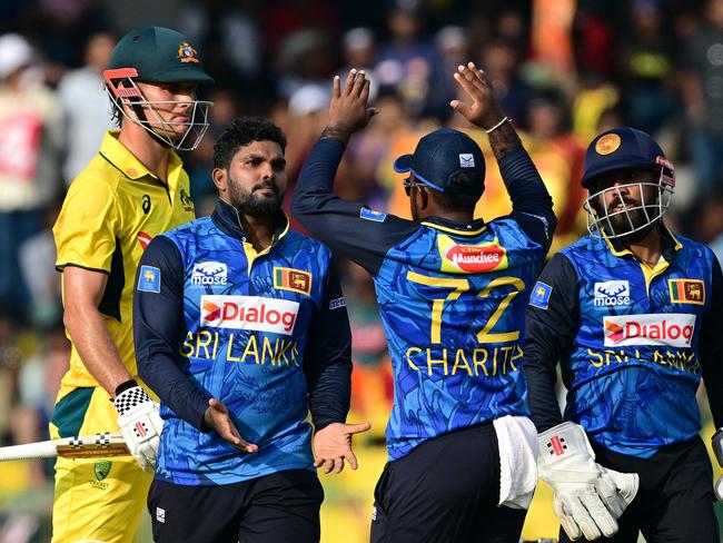 Sri Lanka's Wanindu Hasaranga celebrates with teammates after taking the wicket of Australia's Aaron Hardie. Picture: AFP